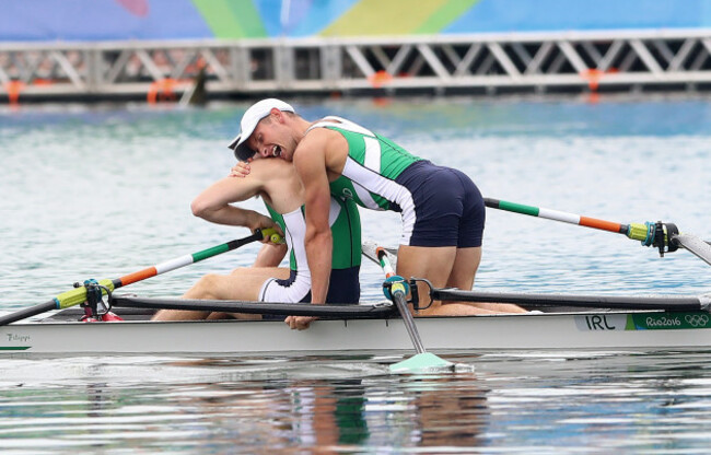 Gary and Paul O'Donovan celebrate winning silver medals