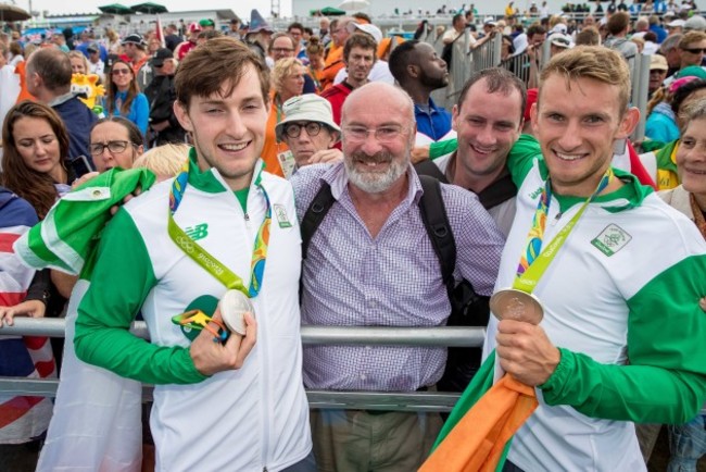 Paul and Gary O'Donovan celebrate winning a silver medal with father Teddy and brother David O'Donovan