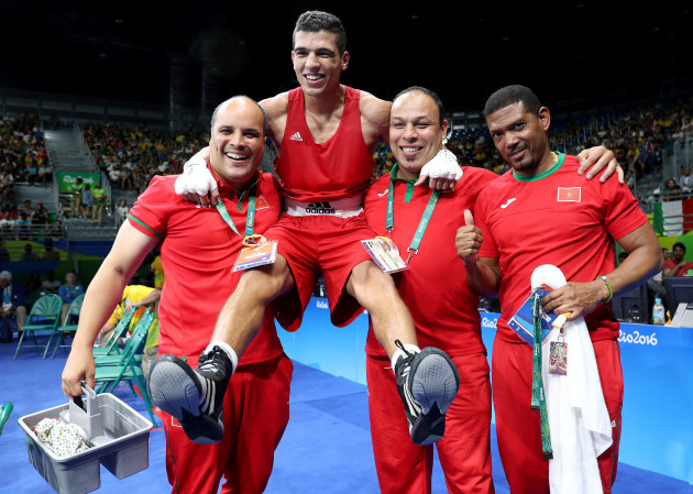 Mohammed Rabii of Morocco celebrates with his coaches after the fight