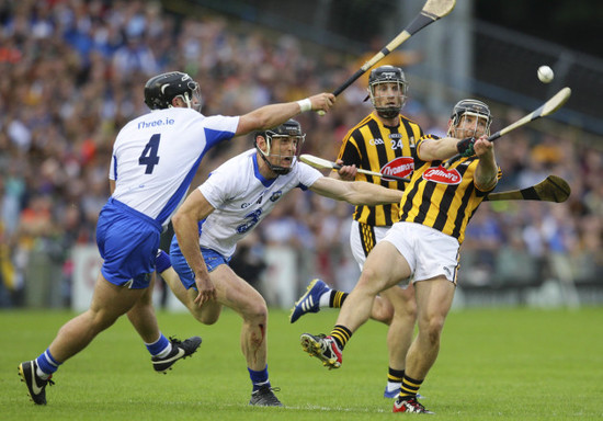 Richie Hogan shoots under pressure from Kevin Moran