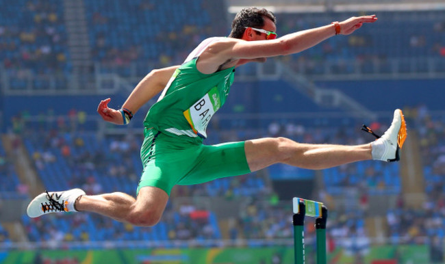 Thomas Barr clears the first hurdle during his heat