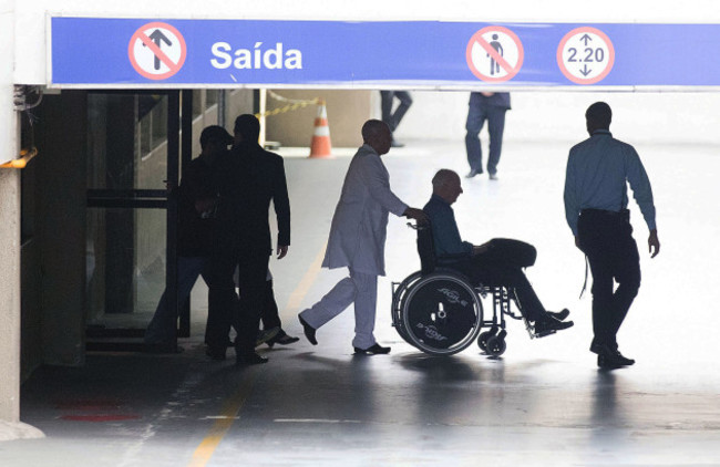 Pat Hickey is escorted from hospital