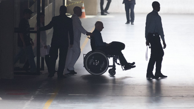 Pat Hickey is escorted from hospital