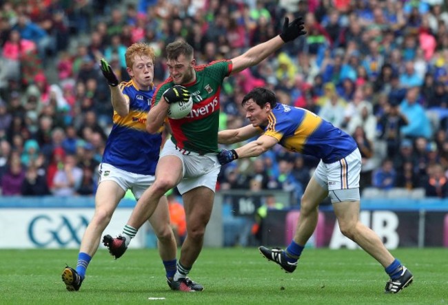 Aidan O'Shea tackled by Josh Keane and Ciaran McDonald