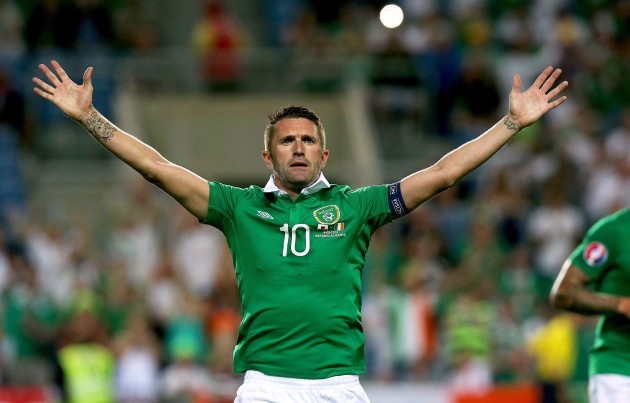 Robbie Keane celebrates scoring their third goal from the penalty spot