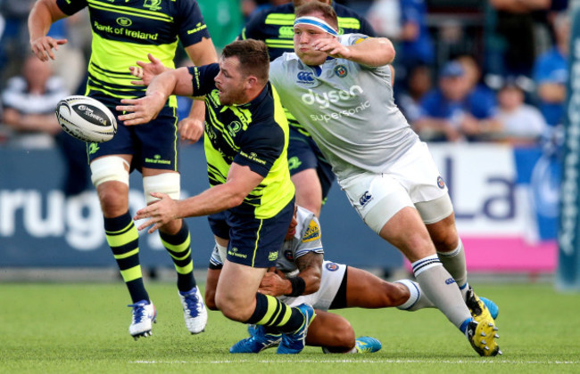 Cian Healy makes a pass despite being being tackled