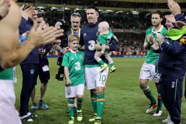 Robbie Keane with his sons Robert and Hudson are applauded off the pitch by team mates at the end of the game