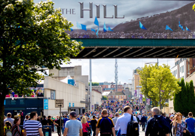 Fans make there way down Jones Road on the way to the game