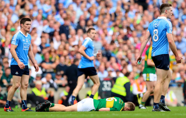 Peter Crowley lies injured after a late challenge