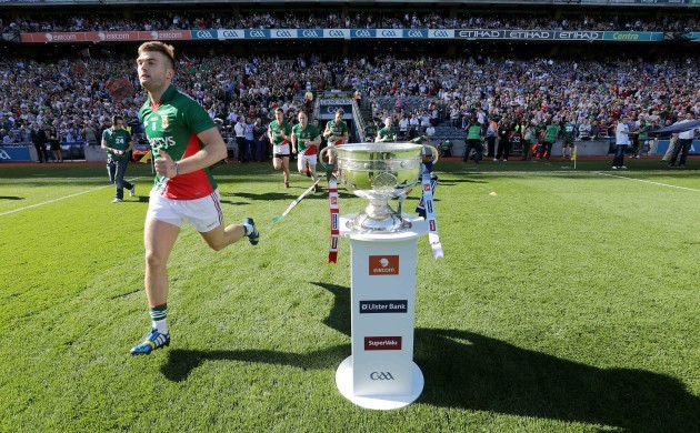 Mayo players run past the Sam Maguire