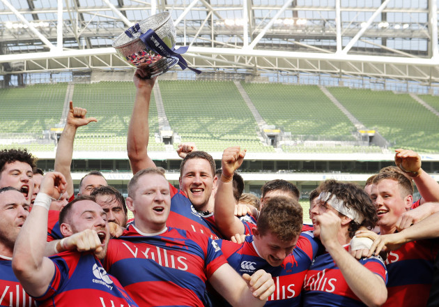 Ben Reilly lifts the Ulster Bank League trophy as his team celebrate winning