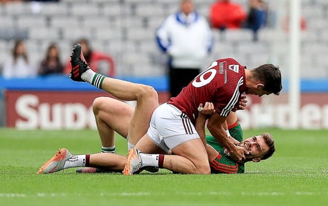 Denis Corroon and Aidan O'Shea tussle off the ball