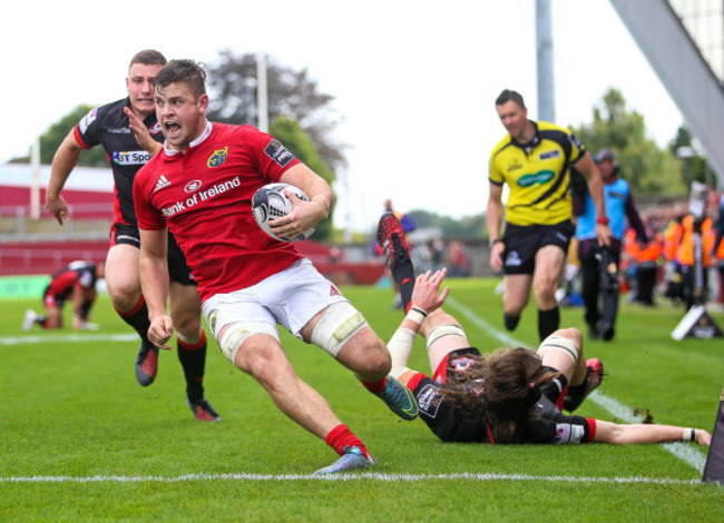 Conor Oliver runs to score a try