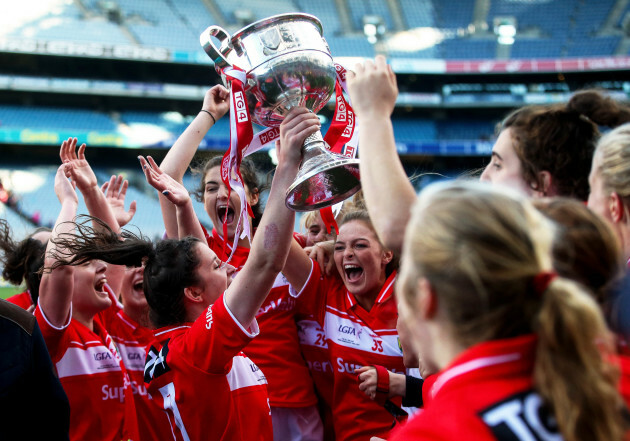 Ciara O'Sullivan raises the trophy in the air as the team celebrates