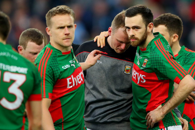 Robert Hennelly consoled by Andy Moran and Kevin McLoughlin after the game