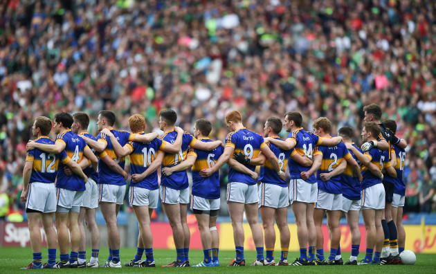 The Tipperary team stand for the national anthem