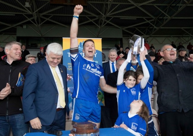 Thurles Sarsfields captain Padraic Maher raises the senior trophy with Laragh, Isabelle and Emma Griffin