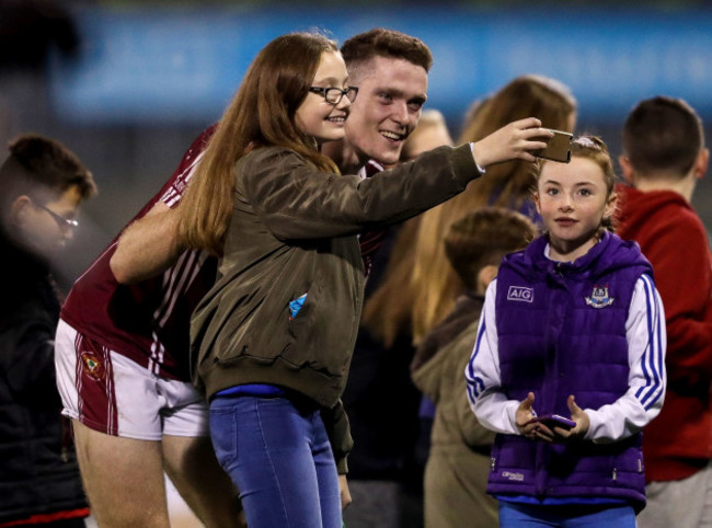 Brian Fenton takes photos with fans after the game