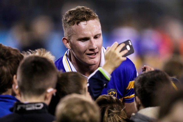 Ciaran Kilkenny takes photos with fans at the end of the game