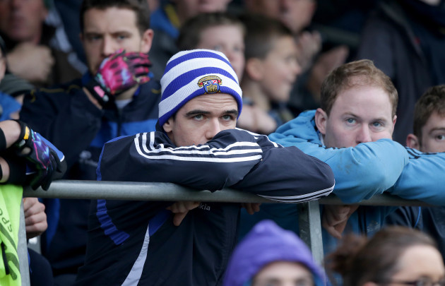 Ger Brennan watches from the stands after being sent off early in the game