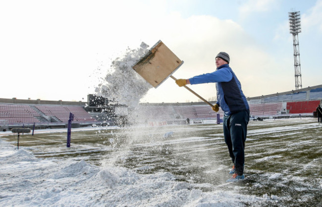 Snow is cleared form the pitch before the game