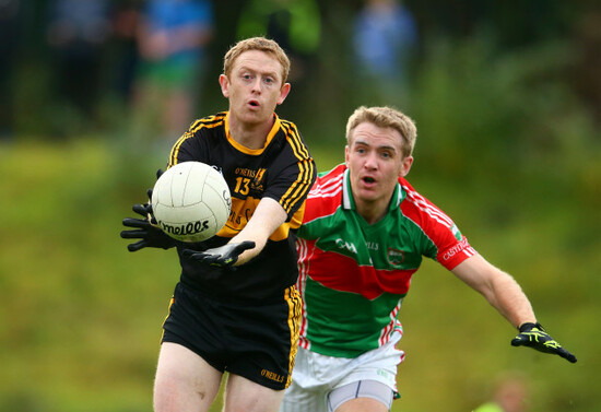 Colm Cooper is tackled by Noel McGrath