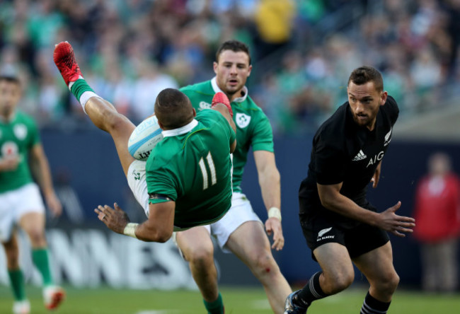 Ireland’s Simon Zebo is tackled by New Zealand All Blacks’s Aaron Cruden