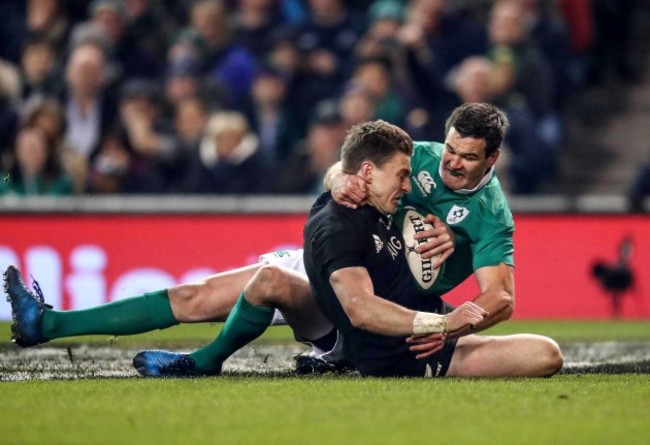 Beauden Barrett scores a try despite the efforts of Jonathan Sexton