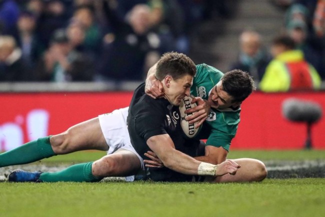 Beauden Barrett scores a try despite the efforts of Jonathan Sexton