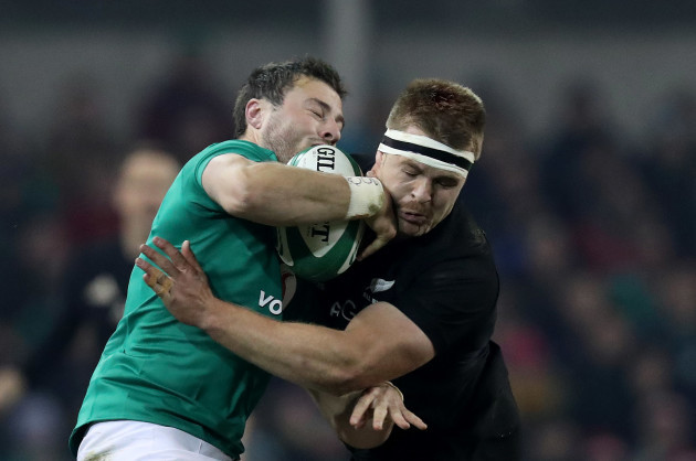 Ireland’s Robbie Henshaw is tackled by New Zealand All Blacks Sam Cane