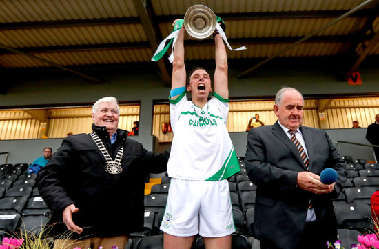 Brian Hogan lifts the trophy