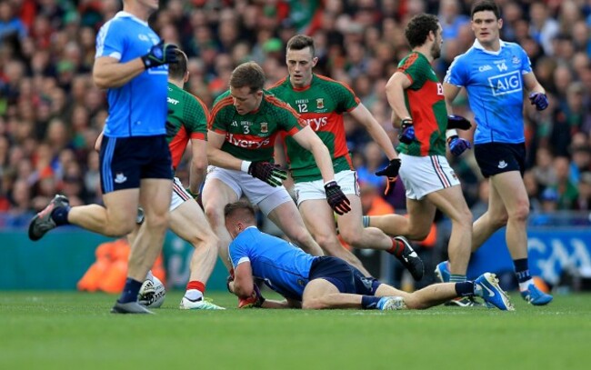 Jonny Cooper holds back Donal Vaughan