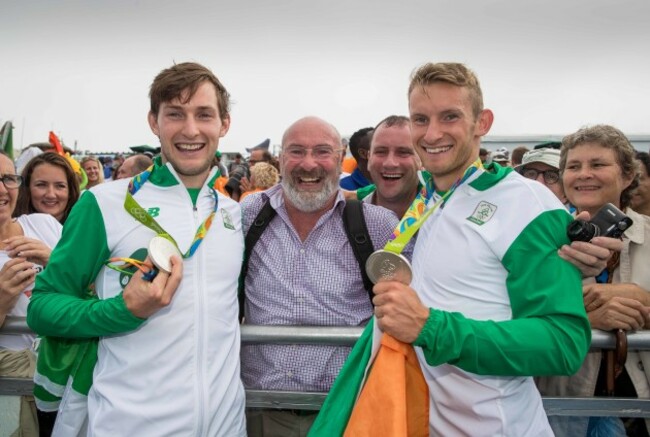 Paul and Gary O'Donovan celebrate winning a silver medal with father Teddy and brother David O'Donovan
