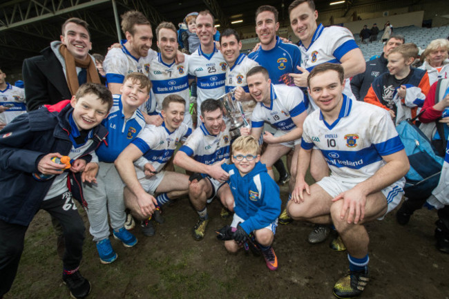 St. Vincent's players celebrate with the trophy