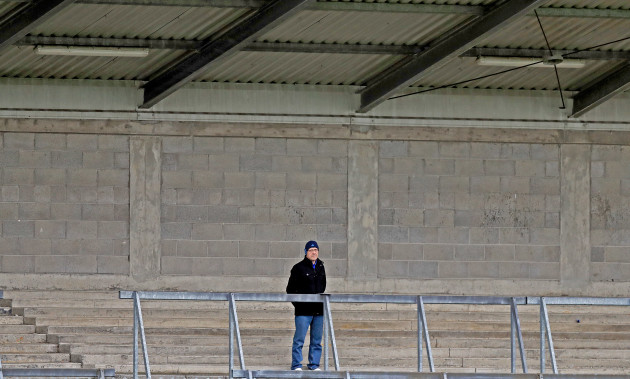 A lone spectator looks on