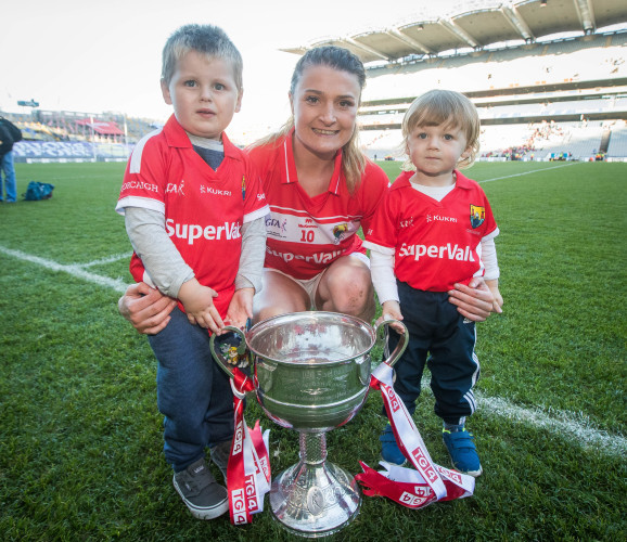 Annie Walsh celebrates with her nephews Colm Walsh and Ryan Mackey and the trophy