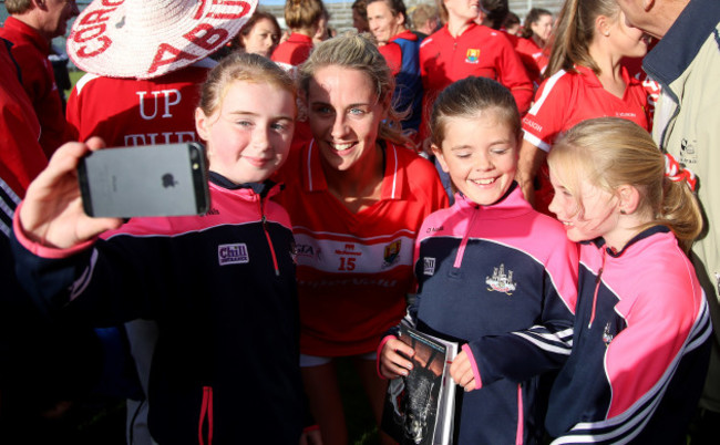 Orla Finn poses in photographs for fans after the game