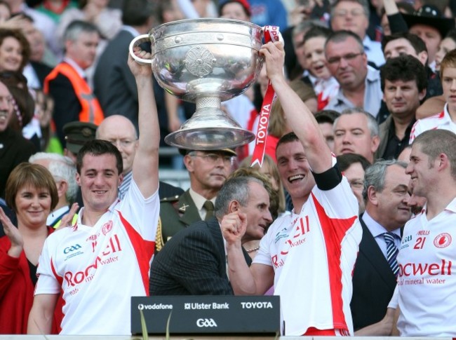 Brian and Tommy McGuigan lift the Sam MaGuire Cup