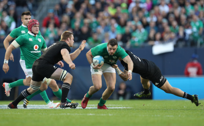 Ireland’s Robbie Henshaw is tackled by New Zealand All Blacks’s Sam Cane and Aaron Cruden