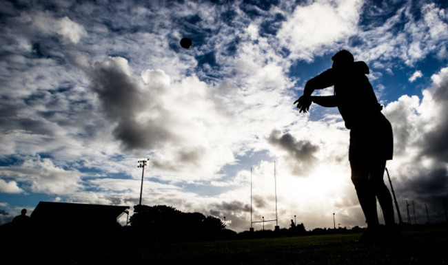 Tom McCartney warms up before the game