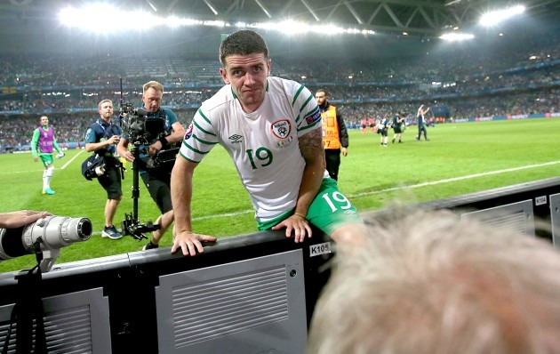 Robbie Brady jumps the advertising hoarding at the end of the game