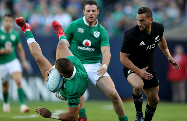 Ireland’s Simon Zebo is tackled by New Zealand All Blacks’s Aaron Cruden