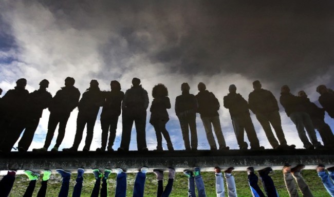 Supporters are reflected in flood waters in front of the main stand