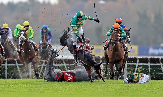 Campeador ridden by Barry Geraghty falls at the last as Sir Scorpion ridden by Mark Walsh collide with them