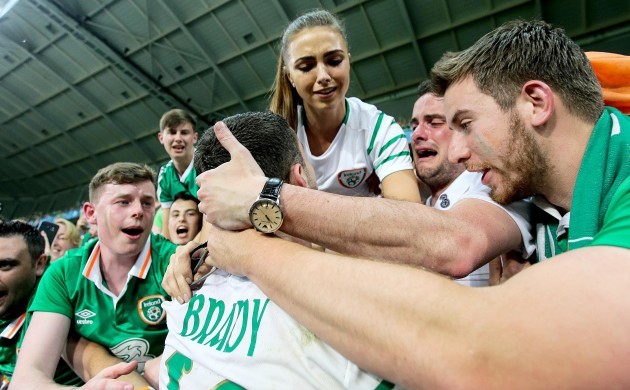 Robbie Brady celebrates with his girlfriend Kerrie Harris and supporters after the game