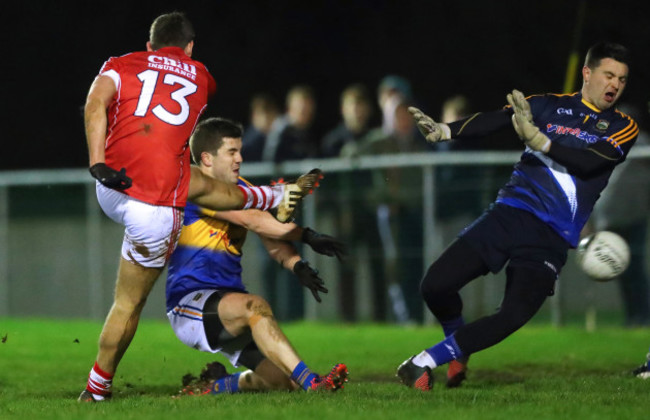 Niall Coakley scores a goal past goalkeeper Ciarán Kenrick