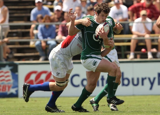 Ireland's Ian Whitten gets tackled
