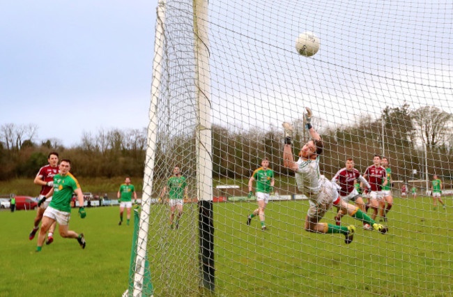 Sean Armstrong (left) scores his sides fifth goal past goalkeeper Phillip Farrelly