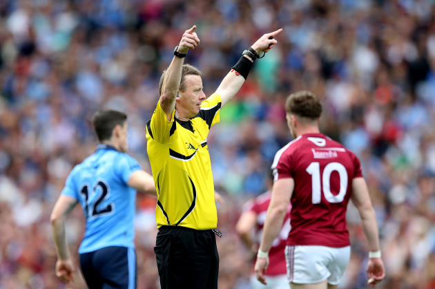 Referee Joe McQuillan signals for Hawk Eye