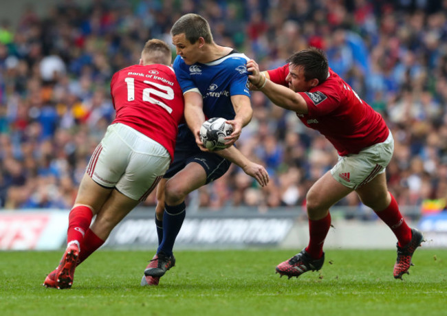 Leinster’s Jonathan Sexton is tackled by Munster’s Rory Scannell and Niall Scannell